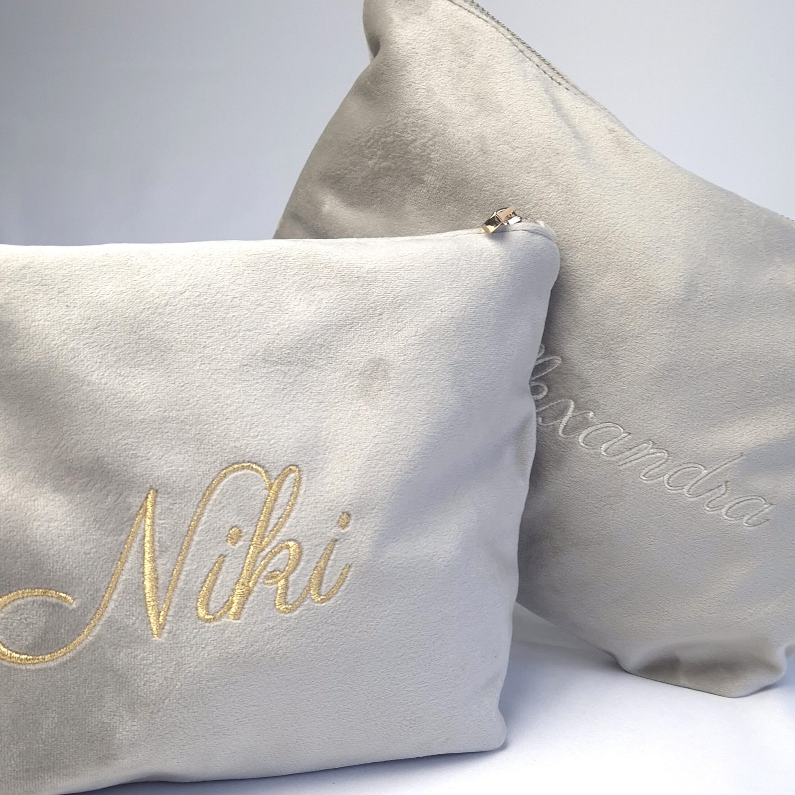 Personalised Grand Toiletry Bags – Customised Names in Gold and Cream Embroidery Two Grand Toiletry Bags from Edoaria’s Ciel des Rêves collection; one personalised with "Niki" in gold and the other with "Alexandra" in cream embroidery.