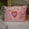 Front view of the Edoaria Rouge Amour Grand Toiletry Bag in soft pink velvet, embroidered with celestial hearts, stars, and moons in dusky pink, gold, and purple.