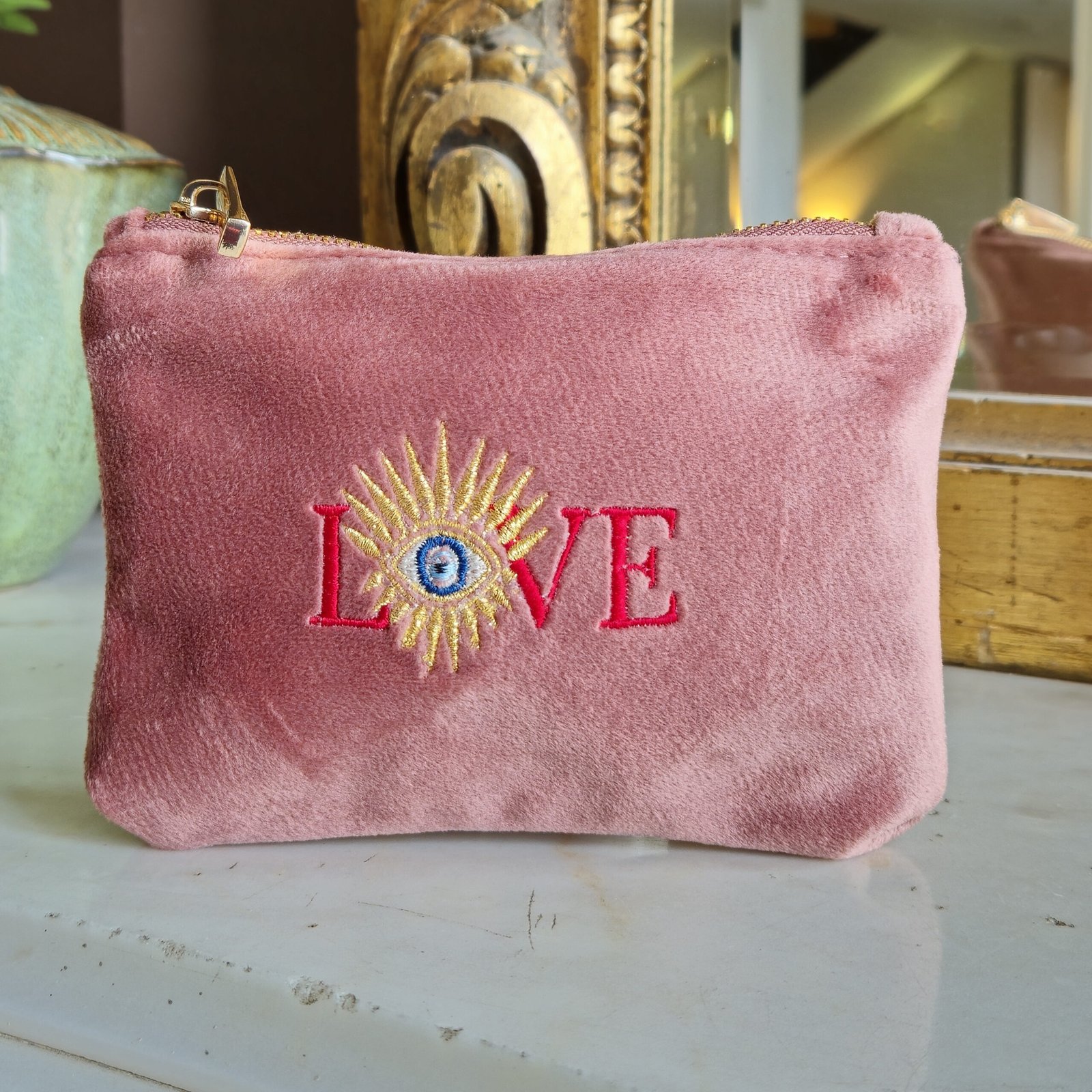 Front view of the Edoaria Rouge Amour Essentials Sleek Pouch in soft pink velvet, featuring celestial embroidery in deep red, dusky pink, gold, and purple.