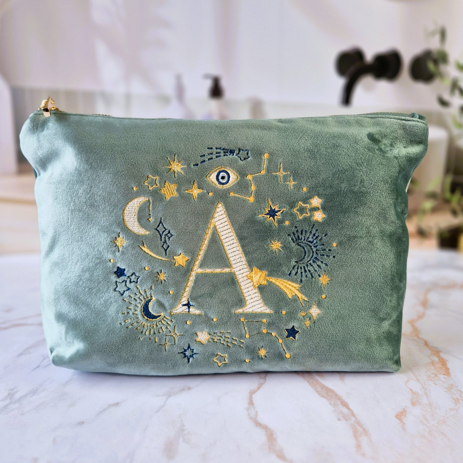 Aqua Marine Teal velvet pouch with gold, cream and blue moon, stars, and evil eye embroidery, part of the Ciel des Rêves collection by Edoaria, limited-edition prototype toiletry bag.