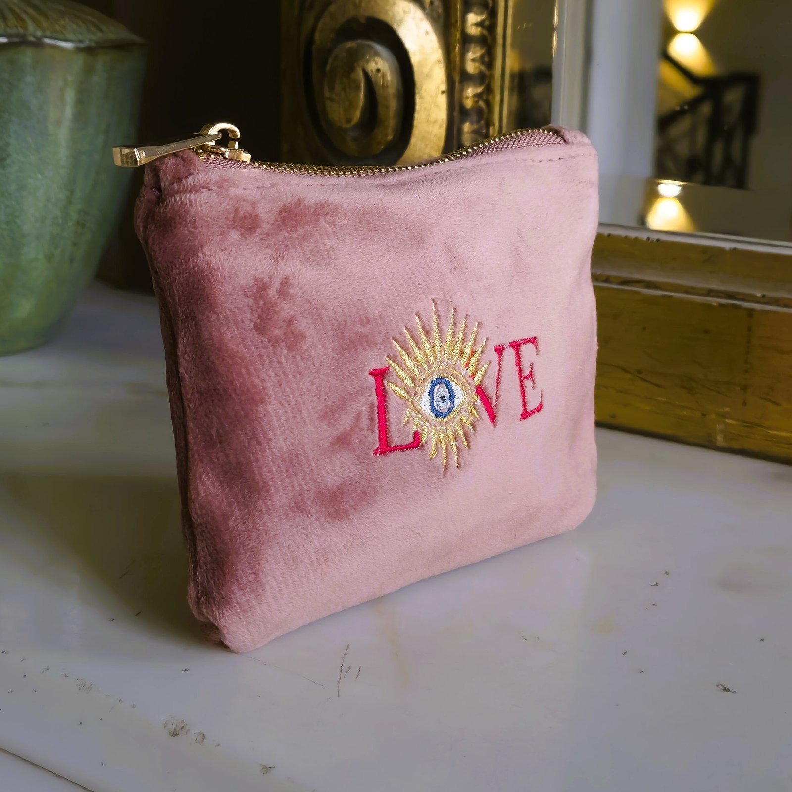 Angled view of the Rouge Amour Essentials Sleek Pouch, showcasing its sleek design and intricate celestial embroidery.