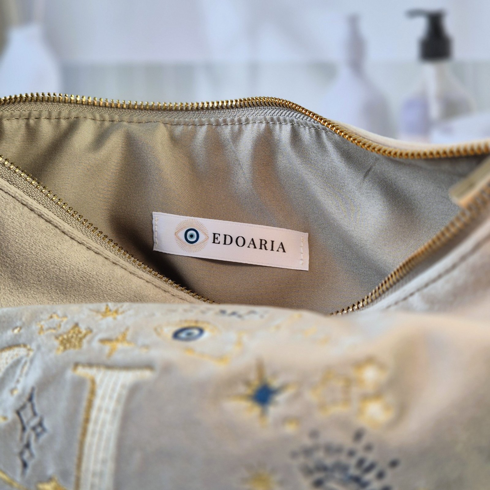 Ciel des Rêves Velvet Pouch – Beige Moonstone with Gold and Blue Embroidery Beige Moonstone velvet opened pouch with beige lining and Edoaria Label, part of the Ciel des Rêves collection by Edoaria, limited-edition prototype toiletry bag.