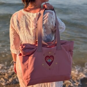 Alexandra, our owner, wearing the Edoaria Everyday tote bag from the Rouge Amour collection with sacred heart and evil eye embroidery